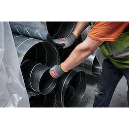 Person wearing Cut Level 8 High-Dexterity Nitrile Dipped Gloves - L handles large metal ducts, showcasing the glove's protective features.