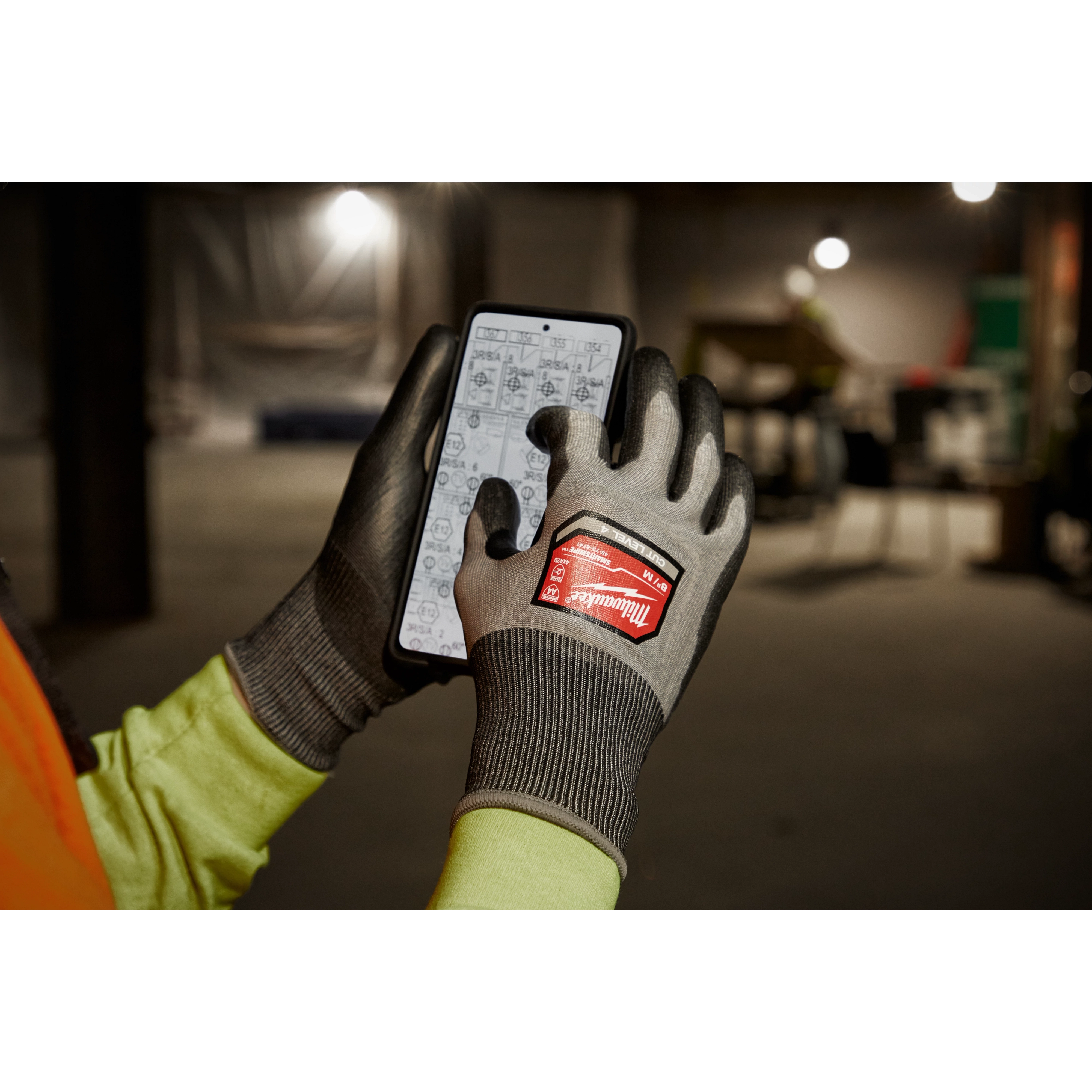 Worker wearing the Cut 4 High-Dexterity Gloves while using a tablet