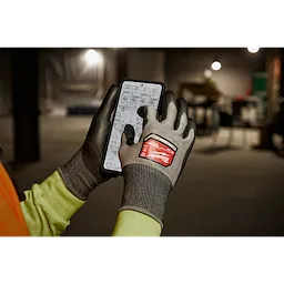 Worker wearing the Cut 4 High-Dexterity Gloves while using a tablet