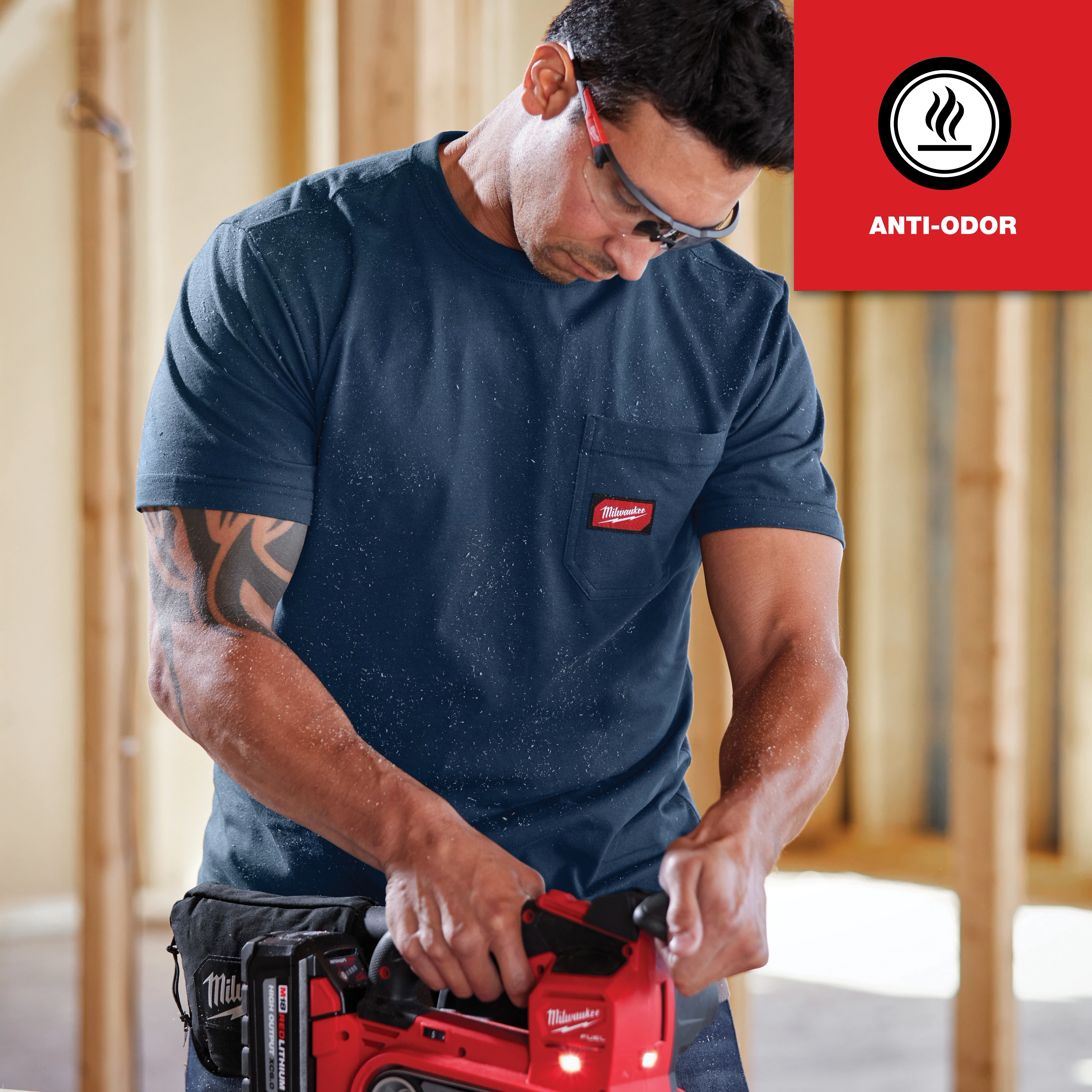 Man wearing GRIDIRON Pocket T-Shirt - Short Sleeve Anti-odor while operating a power tool in a construction setting.
