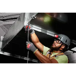 Worker wearing Cut Level 9 High-Dexterity Nitrile Dipped Gloves - L, installing a metal duct while using a headlamp.