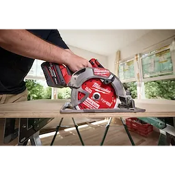 7-1/4" 60T Thick Kerf Ultra Finish Circular Saw Blade mounted on a cordless saw cutting a board indoors.