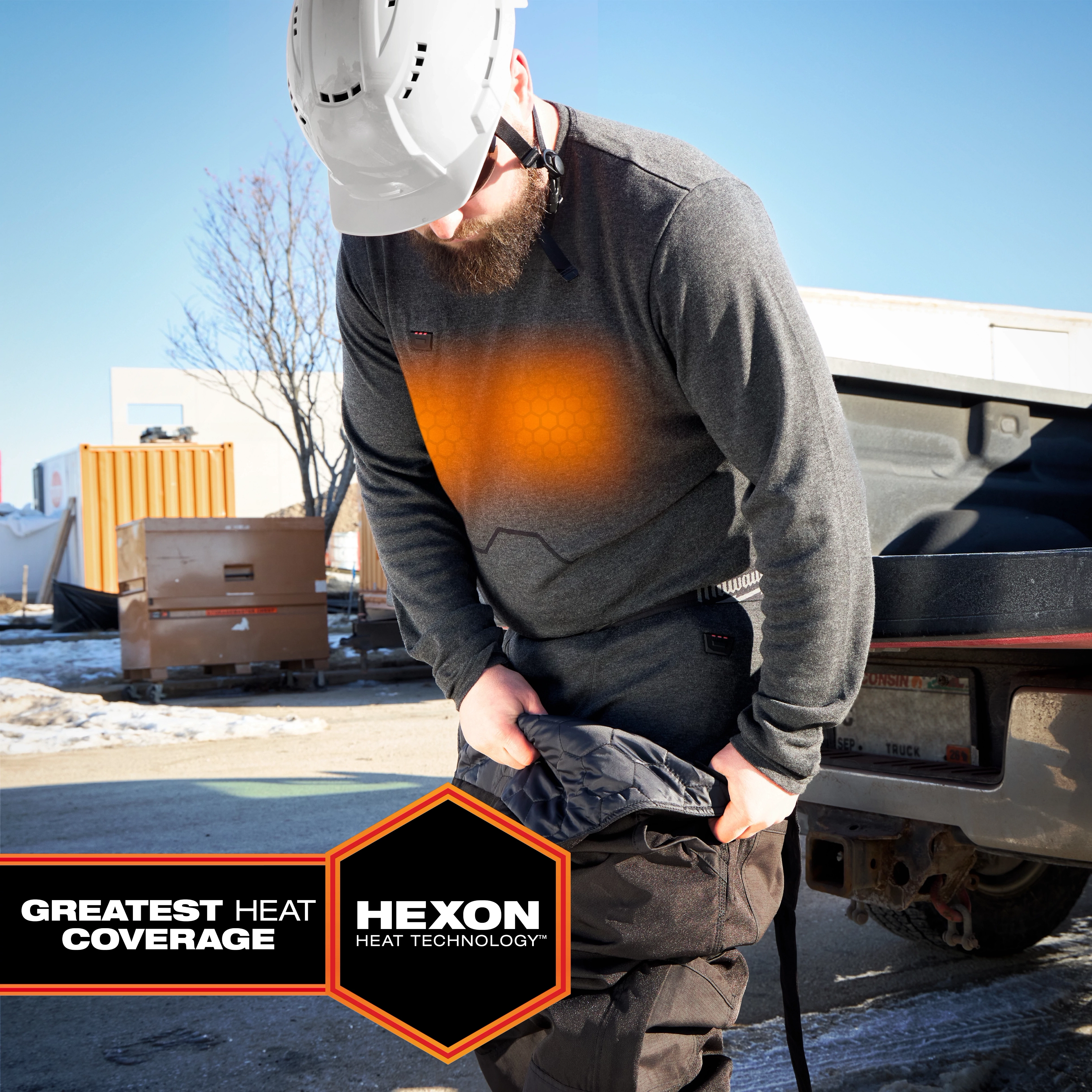Worker wearing Milwaukee Heated Merino Wool Crew Neck Baselayer and Milwaukee Heated Merino Wool Baselayer Pants outdoors
