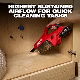 Person using the M18 Brushless Handheld Vacuum to clean wood dust inside a cabinet, with text "Highest Sustained Airflow for Quick Cleaning Tasks."