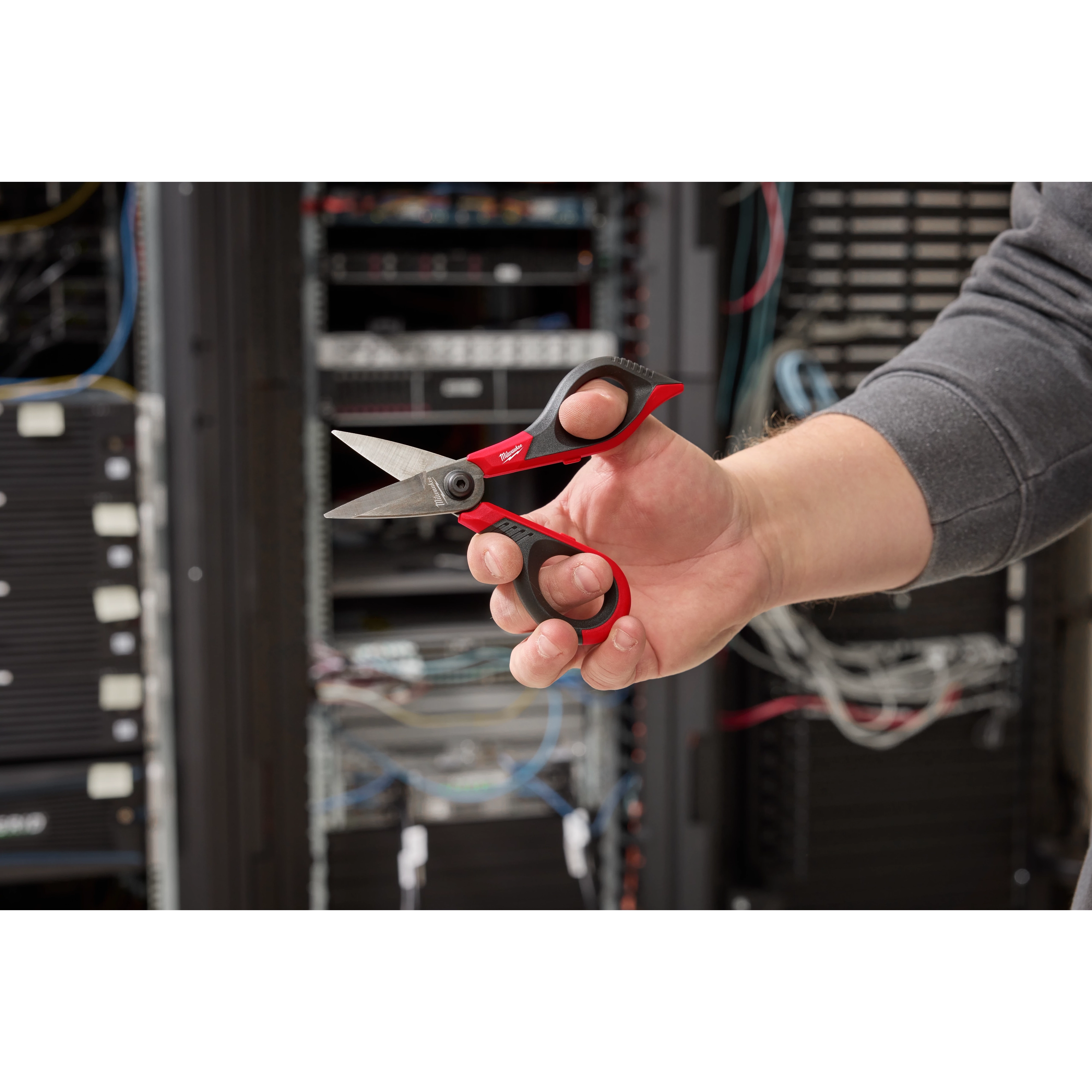 Person displaying the Kevlar Shears while performing electrical work