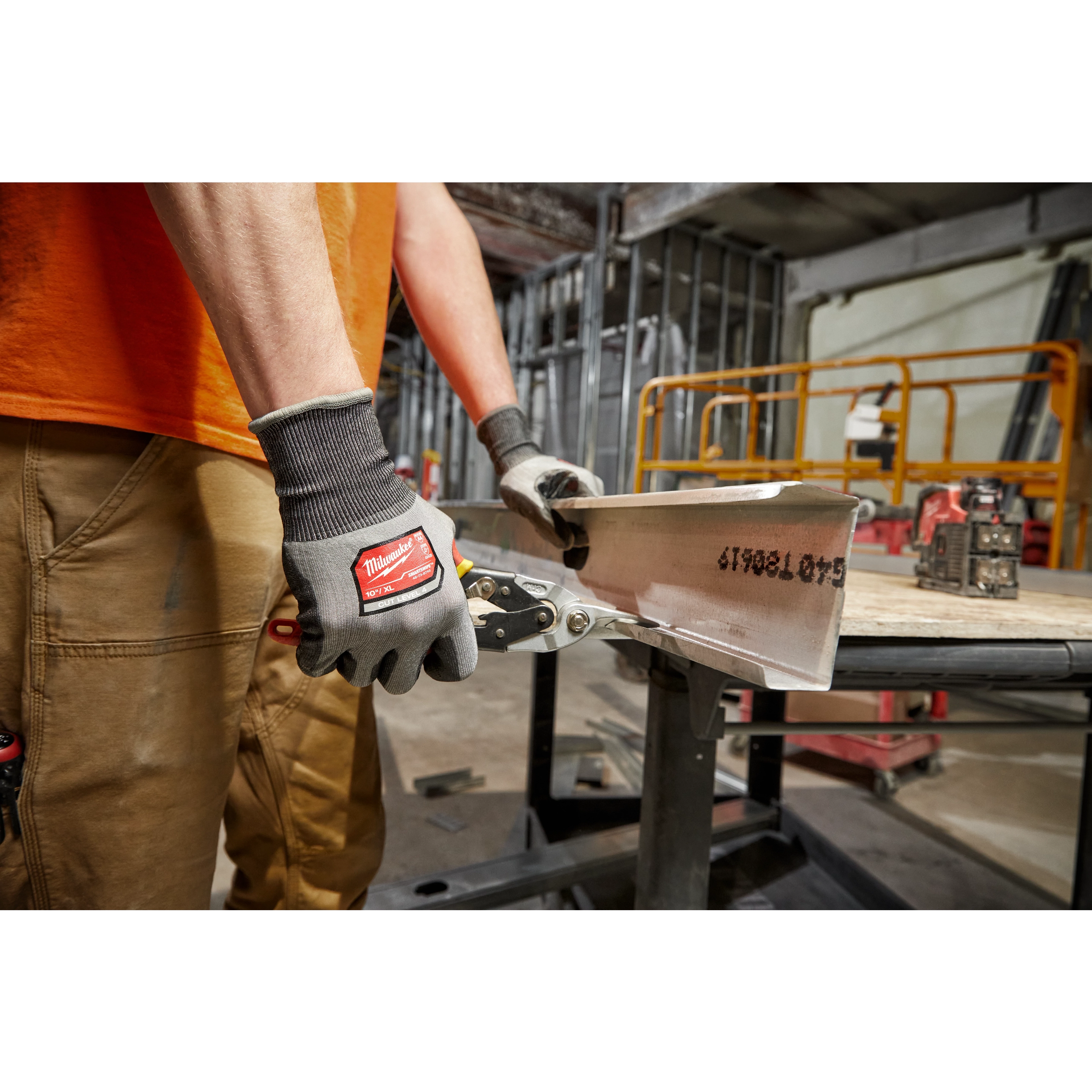 Worker wearing the Cut 4 High-Dexterity Gloves while using a hand tool