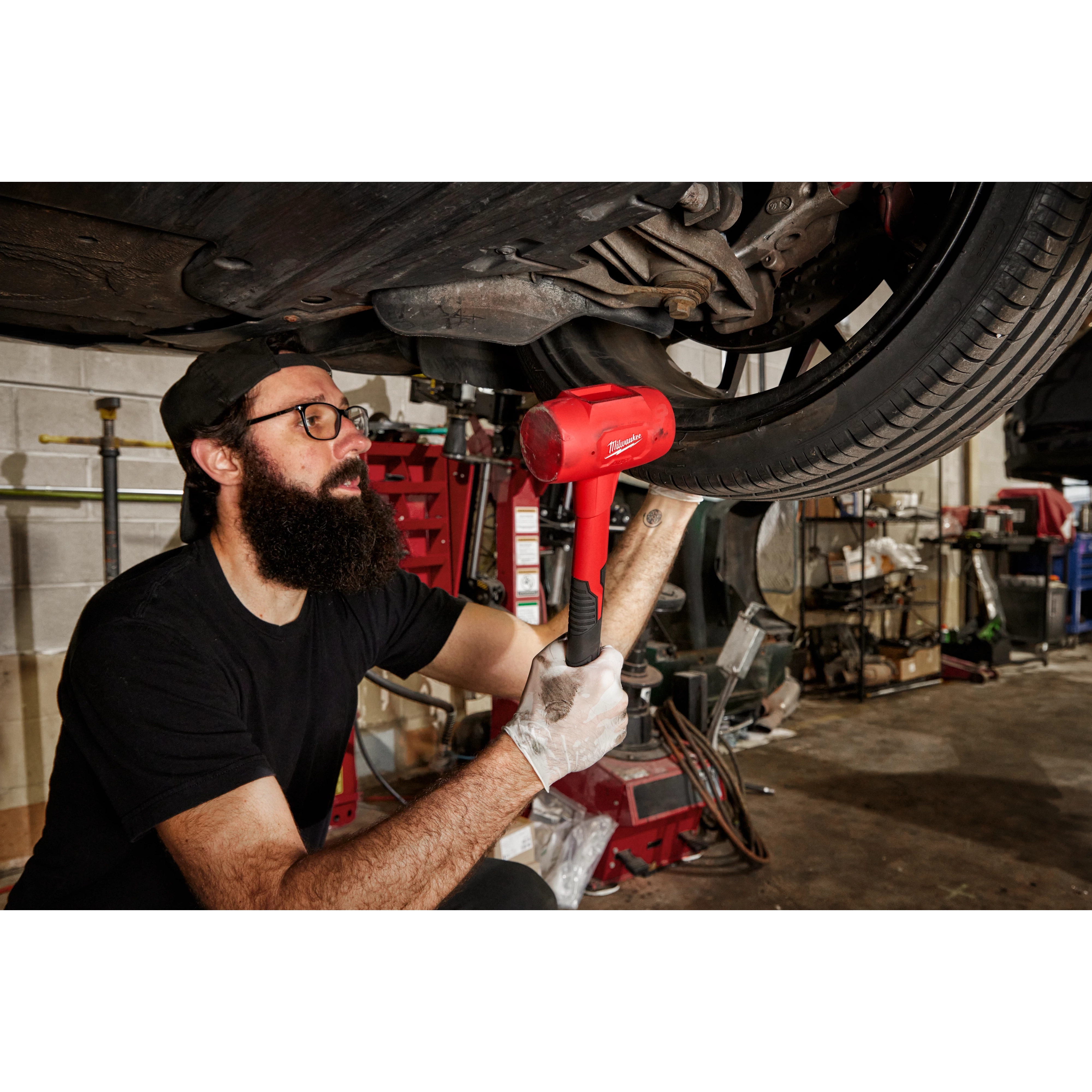 Worker using the 48oz Dead Blow Hammer for automotive use