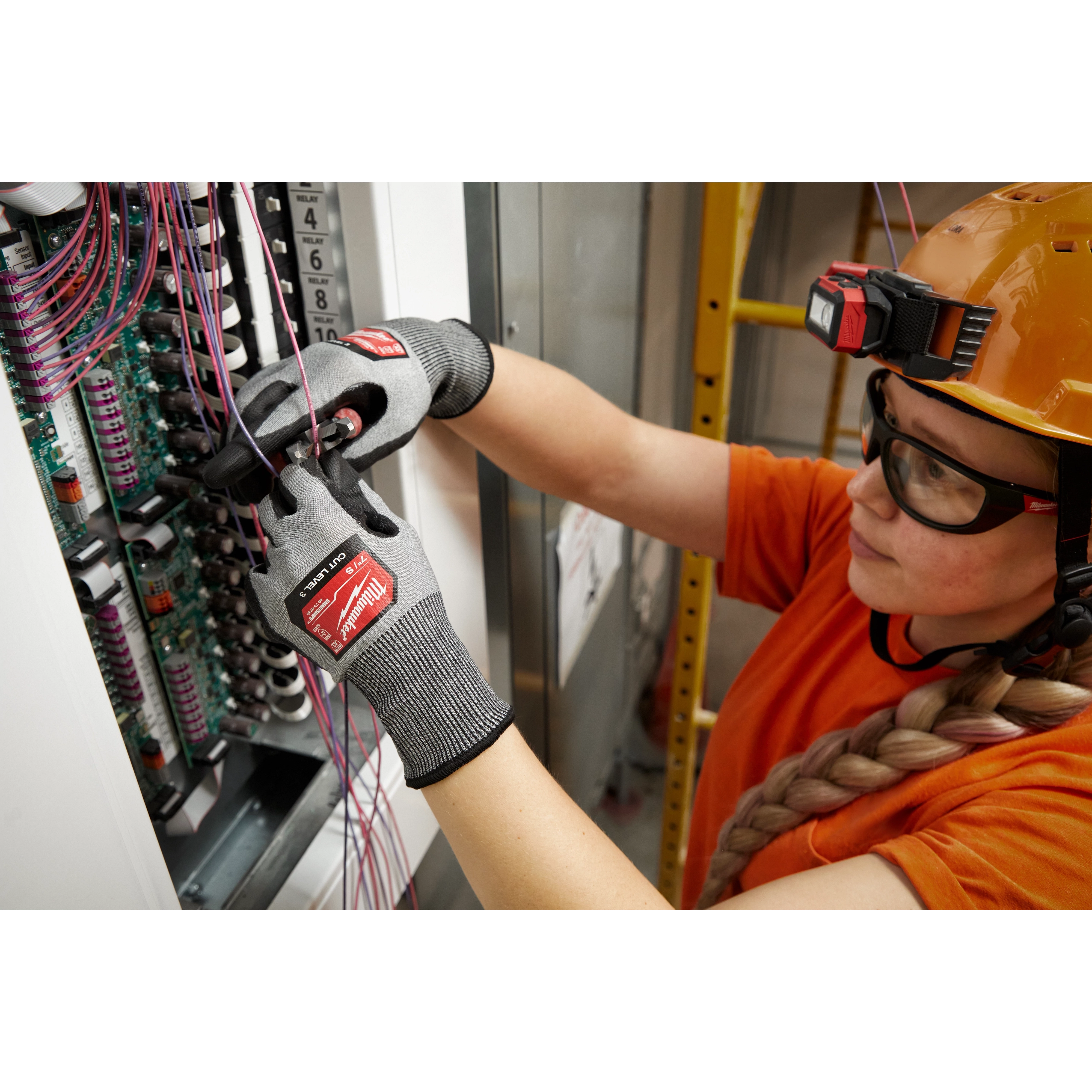 Worker wearing the Cut 3 High-Dexterity Gloves while installing cables