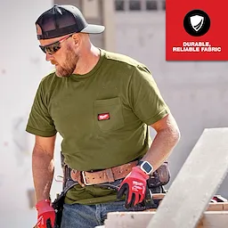 The GRIDIRON Pocket T-Shirt - Short Sleeve is shown in olive green, worn by a worker with a tool belt, highlighting its durability and reliable fabric.