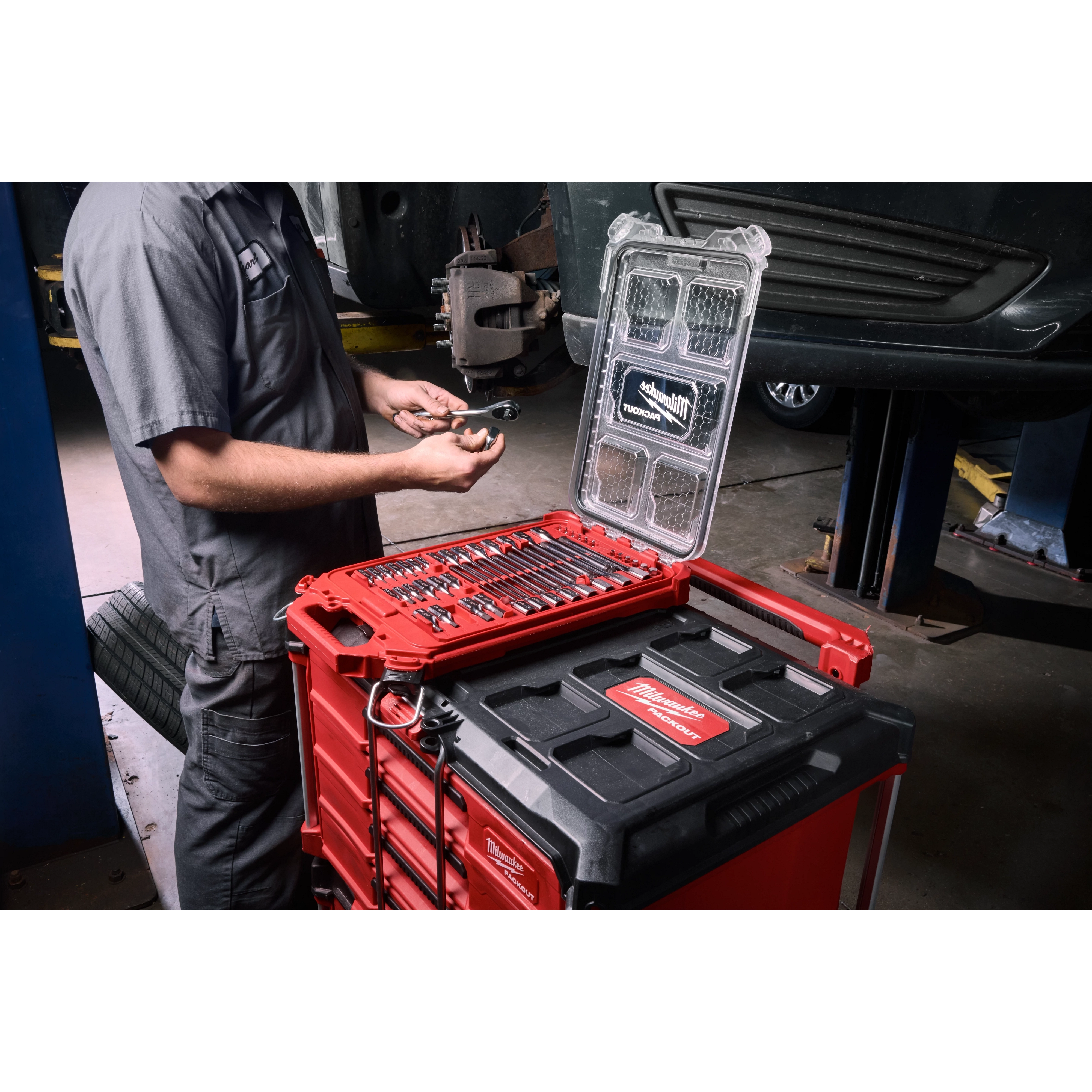Mechanic using the 46pc 1/4” and 3/8” Drive SAE Bit Socket Set with PACKOUT Compact Low-Profile Organizer on a tool stack.
