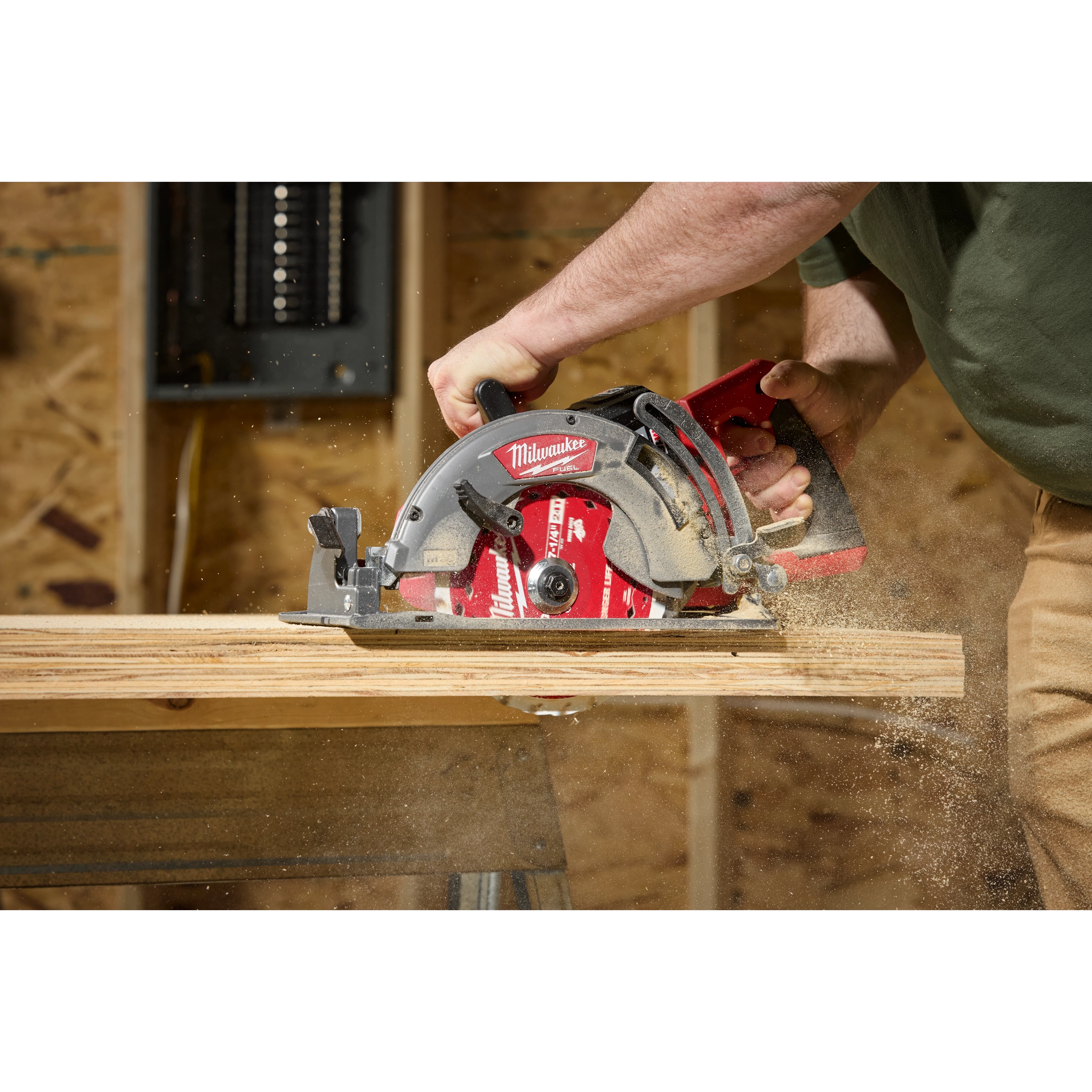 A person is using a Milwaukee circular saw to cut through wood, causing sawdust to fly. The saw is equipped with a 7-1/4" 24T Worm Drive Framing Circular Saw Blade. The environment appears to be a woodworking or construction workspace.