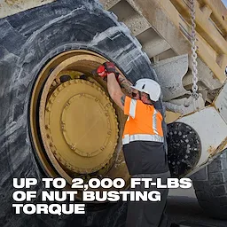 Worker using M18 FUEL 3/4" Extended Anvil High Torque Impact Wrench w/ ONE-KEY Kit on a large vehicle wheel.