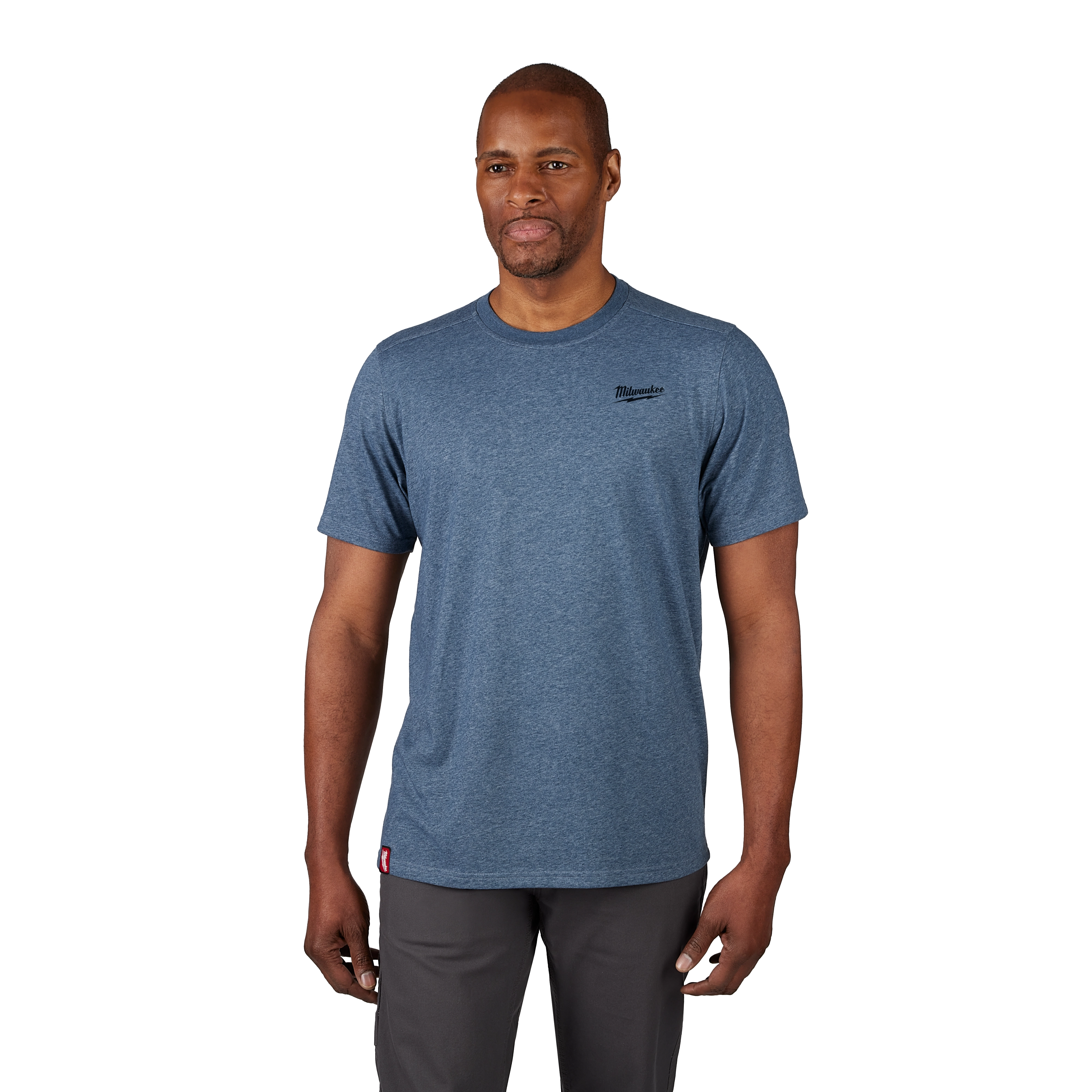 A man wearing a grayish-blue Hybrid Work Tee with short sleeves and a logo on the left chest. He pairs the tee with dark pants.