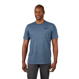 A man wearing a grayish-blue Hybrid Work Tee with short sleeves and a logo on the left chest. He pairs the tee with dark pants.