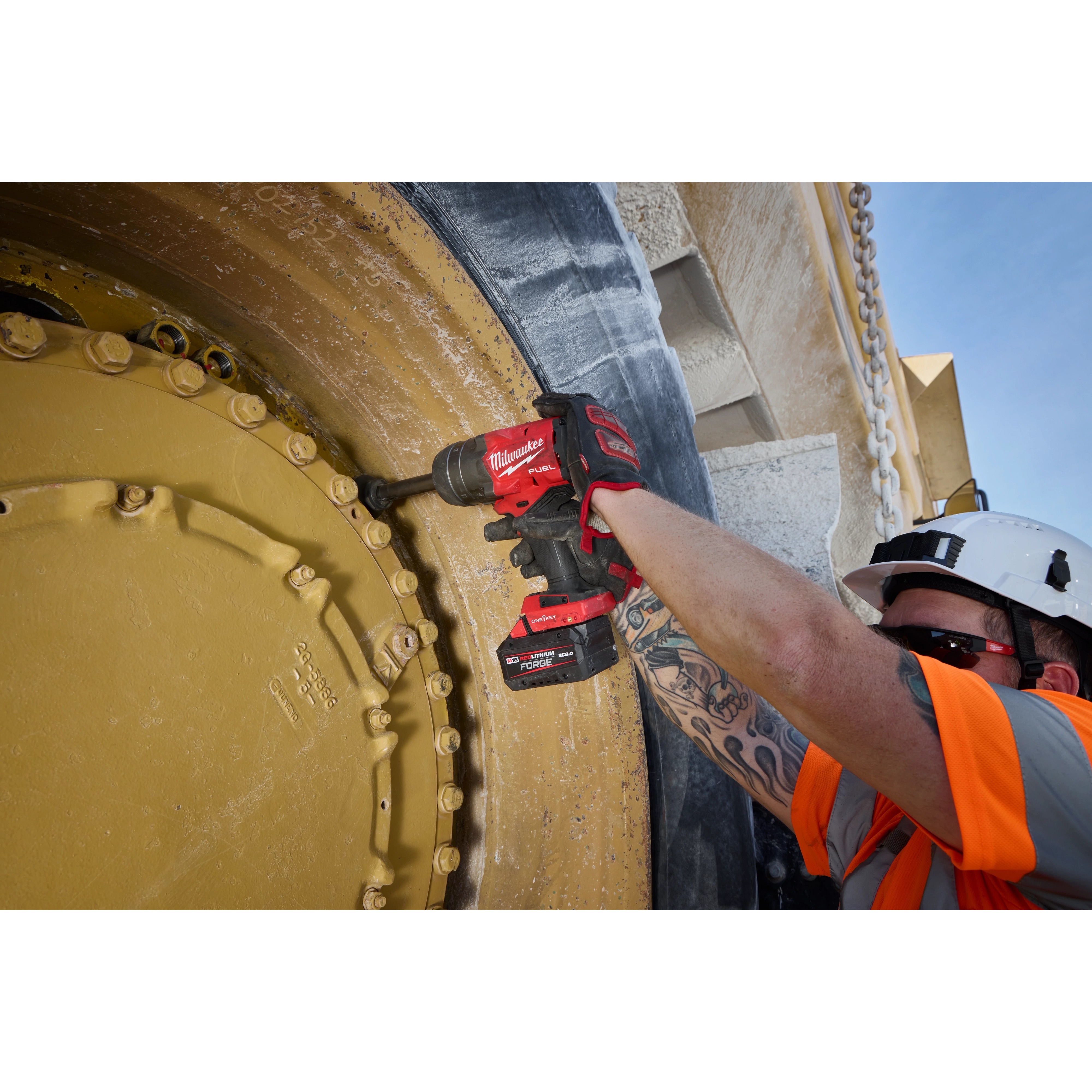 Worker using an M18 FUEL 3/4" Extended Anvil High Torque Impact Wrench w/ ONE-KEY on a large industrial wheel.