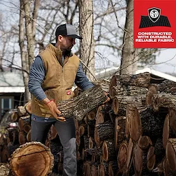 Man wearing the Heavy Duty Sherpa-Lined Vest while handling firewood, with text highlighting the vest's durable, reliable fabric.