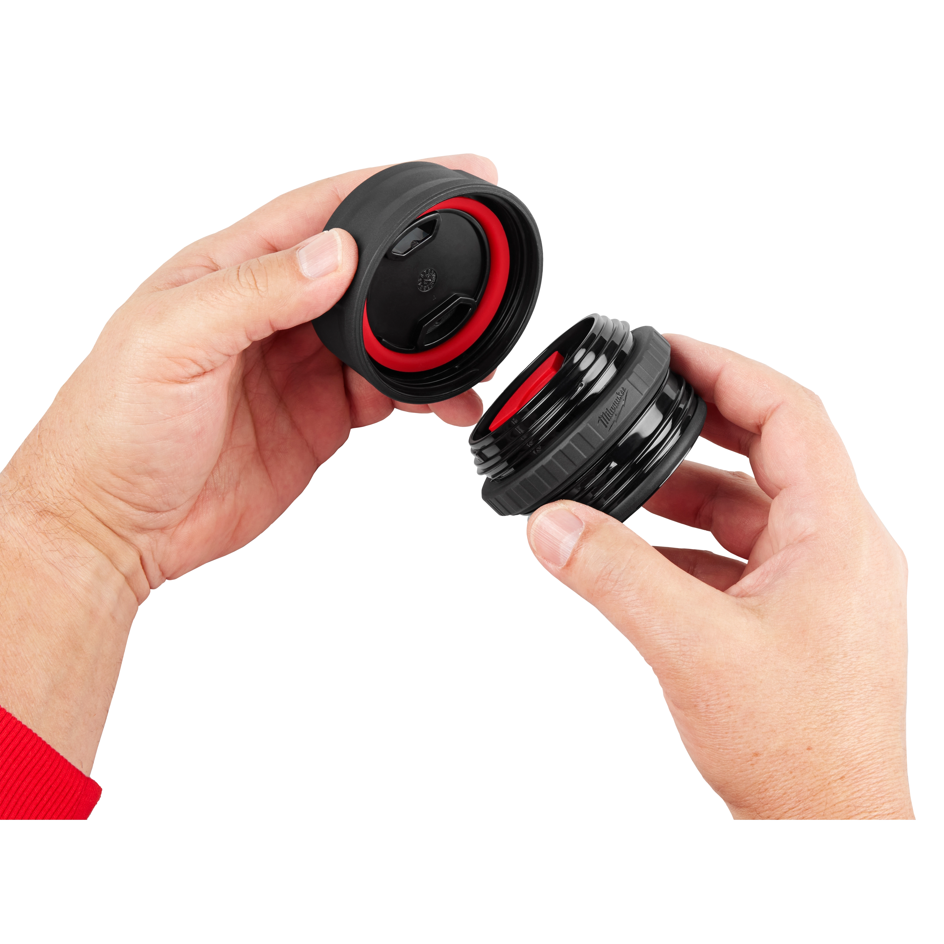 A person holds the PACKOUT Sip Lid, showing the removable cap with a sealing ring and the threaded portion.