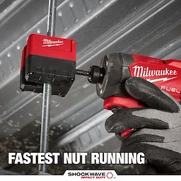 The Milwaukee SHOCKWAVE™ Impact Duty 3/8" Threaded Rod Nut Runner attaches to a threaded rod. A hand wearing a black glove grips a Milwaukee Fuel power drill connected to the nut runner. Text below reads "FASTEST NUT RUNNING" and "SHOCKWAVE™ Impact Duty" in white and red font.