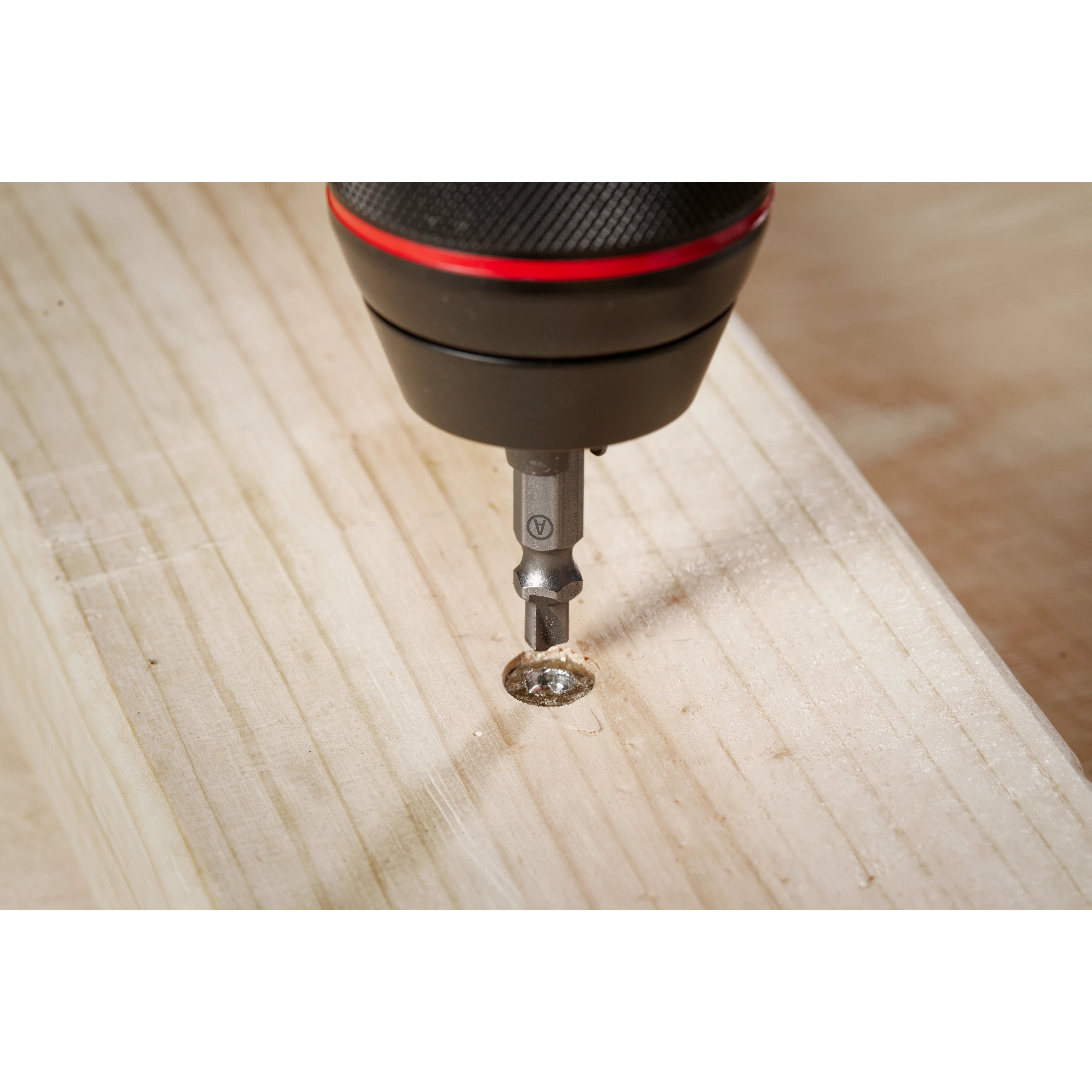 The M2 Steel Screw Extractor Set 4PC is shown in use, extracting a damaged screw from a wooden plank using a power drill. The extractor is focused on the screw head, demonstrating its precision in removing stripped screws.