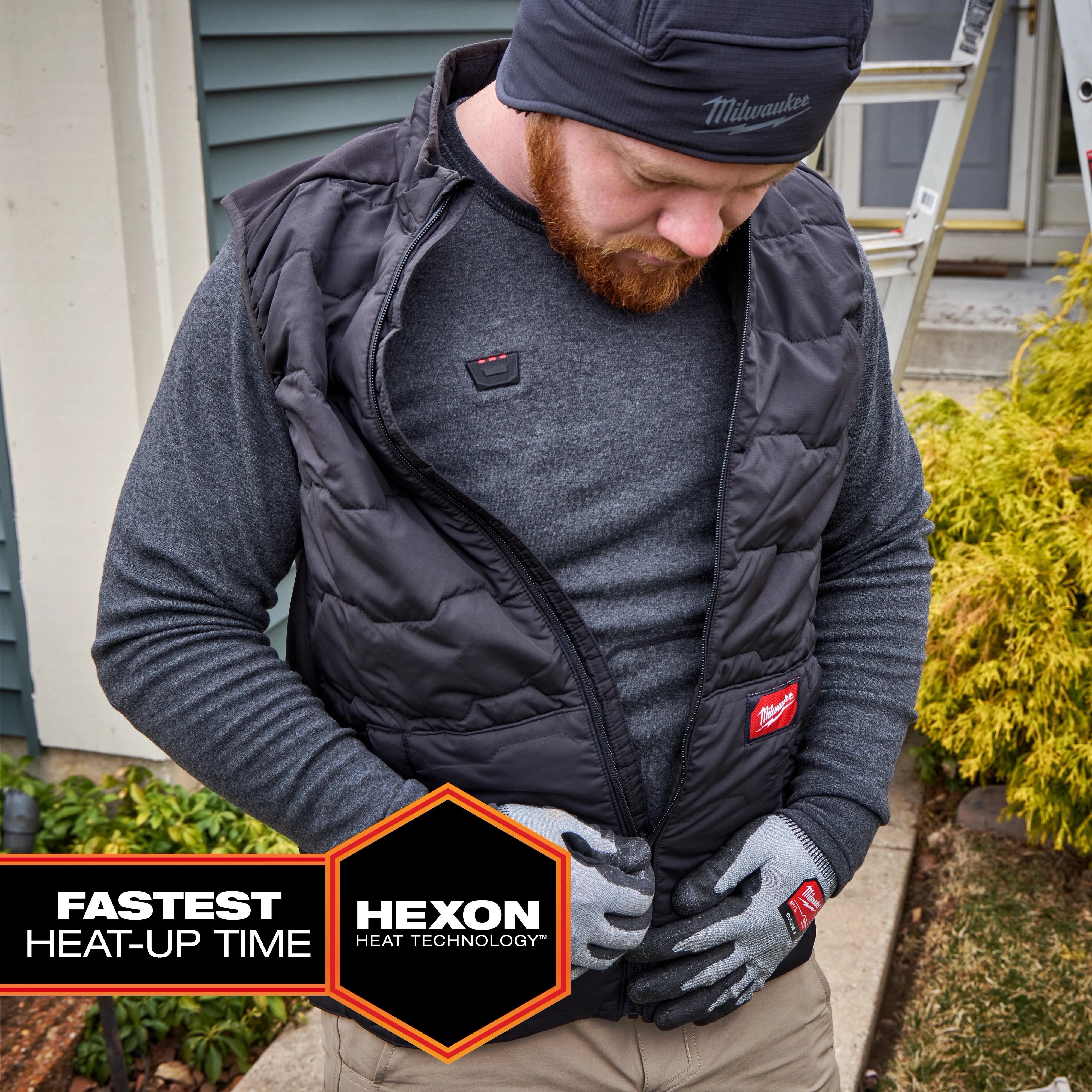 Person wearing a Milwaukee Heated Merino Wool Crew Neck Baselayer under a zippered vest outdoors