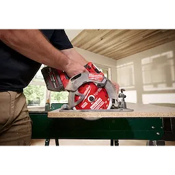7-1/4" 60T Thick Kerf Ultra Finish Circular Saw Blade mounted on a circular saw cutting a board on a workbench.