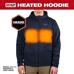The M12™ Heated Hoodie features Hexon Heat Technology, displayed in a glowing orange pattern across the chest area. The hoodie is navy blue, with a black zipper, and the model wearing it is 6' 2" in height and is wearing a size large.