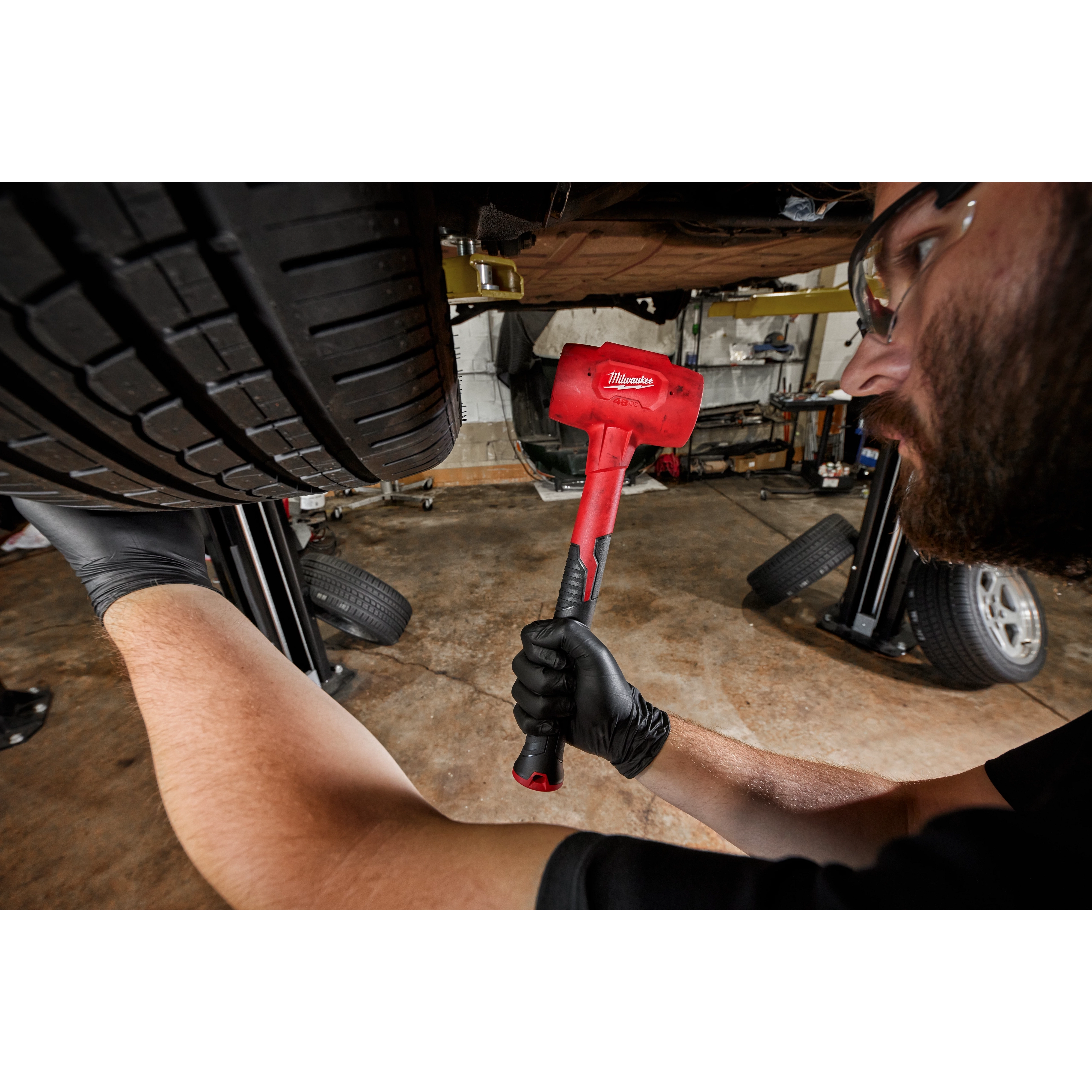 Worker using the 48oz Dead Blow Hammer for automotive use