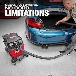 The M18 FUEL™ NEXUS™ 9 Gallon Dual-Battery Wet/Dry Vacuum is being used to clean the trunk of a blue car. The vacuum is cordless and prominently displays the slogan "Clean Anywhere, No Cord Limitations."