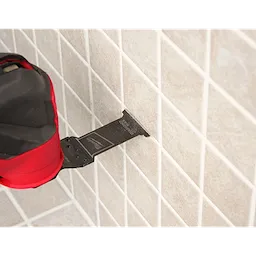 Image of the OPEN-LOK™ DIAMOND MAX™ Diamond Grit Grout Removal Multi-Tool Plunge Blade being used in a Milwaukee Multi-Tool on tile