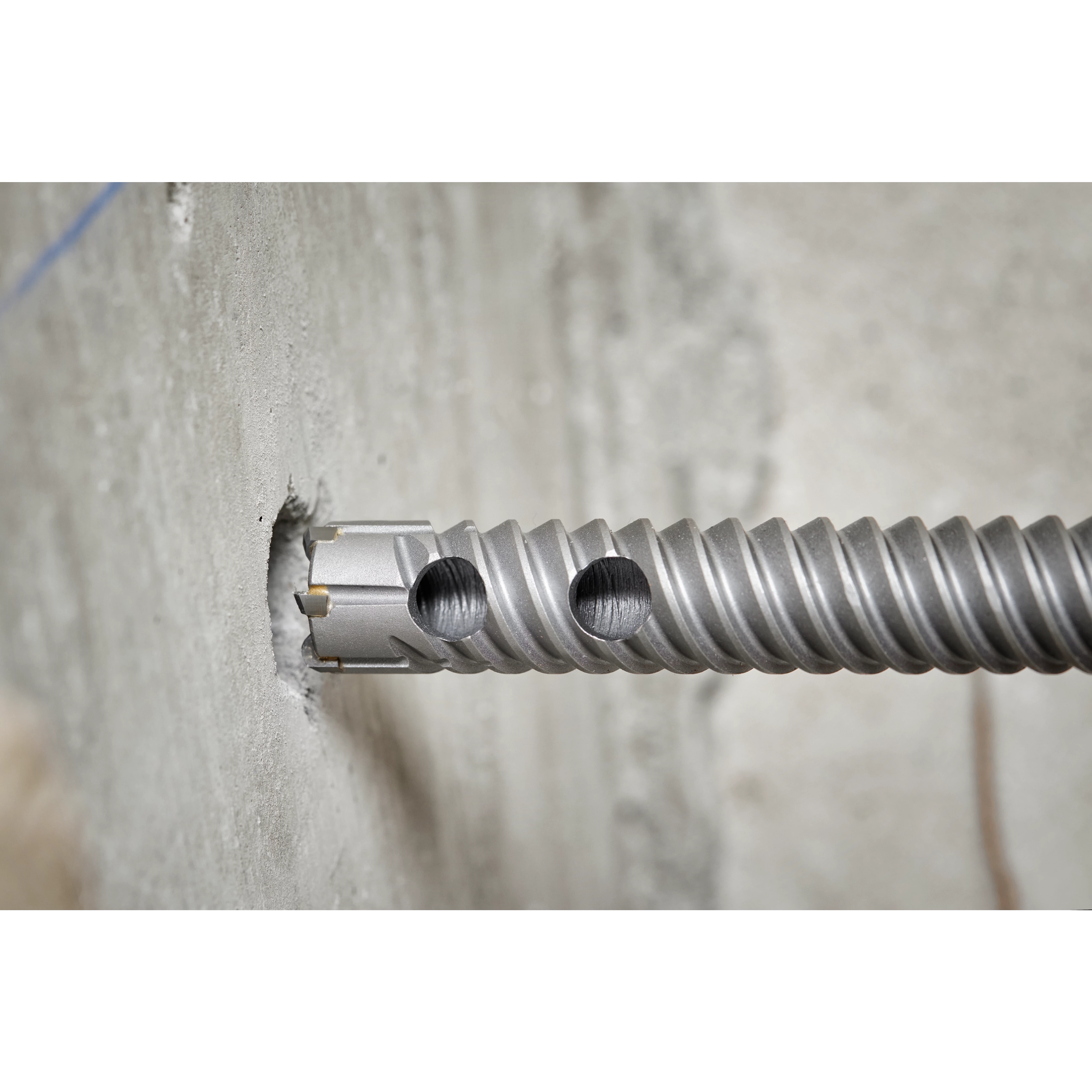 Drill into concrete with a concrete drill bit until rebar is encountered