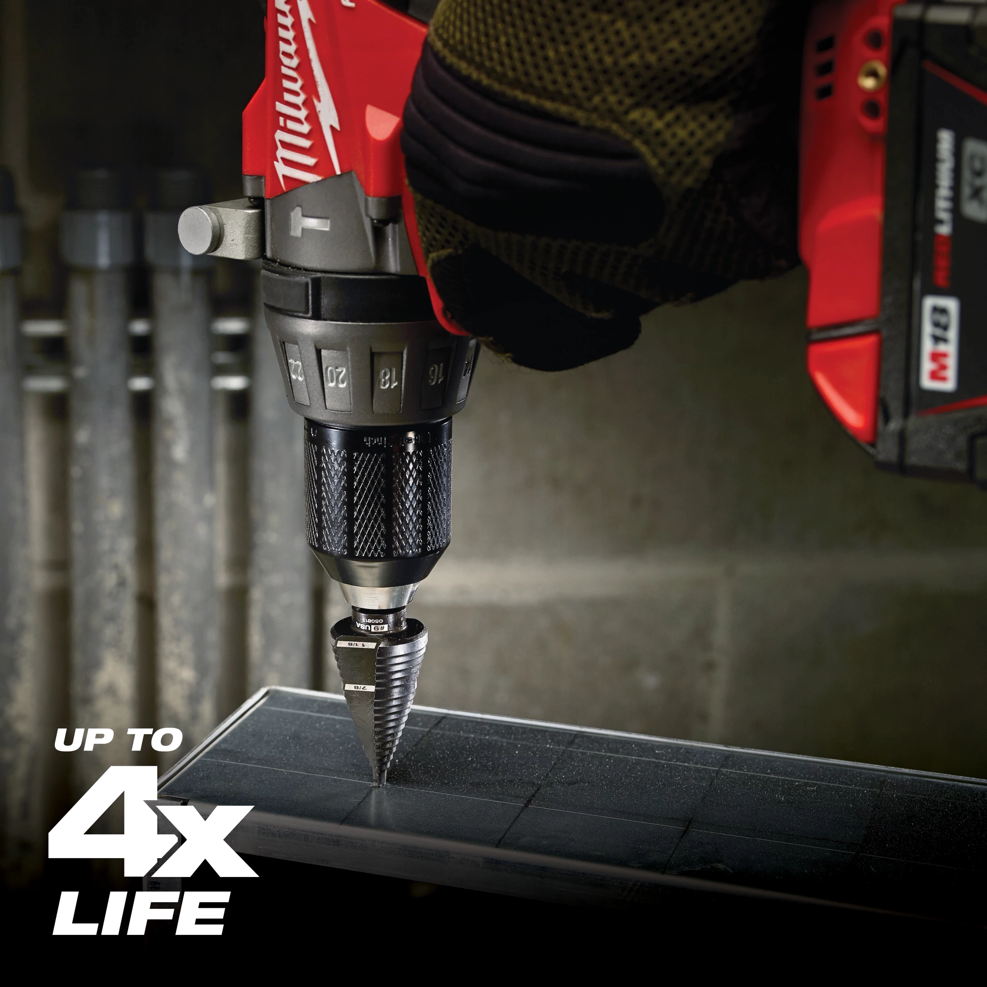 A drill equipped with a Jam Free Step Bits is shown in use, drilling through a piece of metal. Text on the image states "Up to 4x Life." The drill features a red and black color scheme with visible numerical measurements.