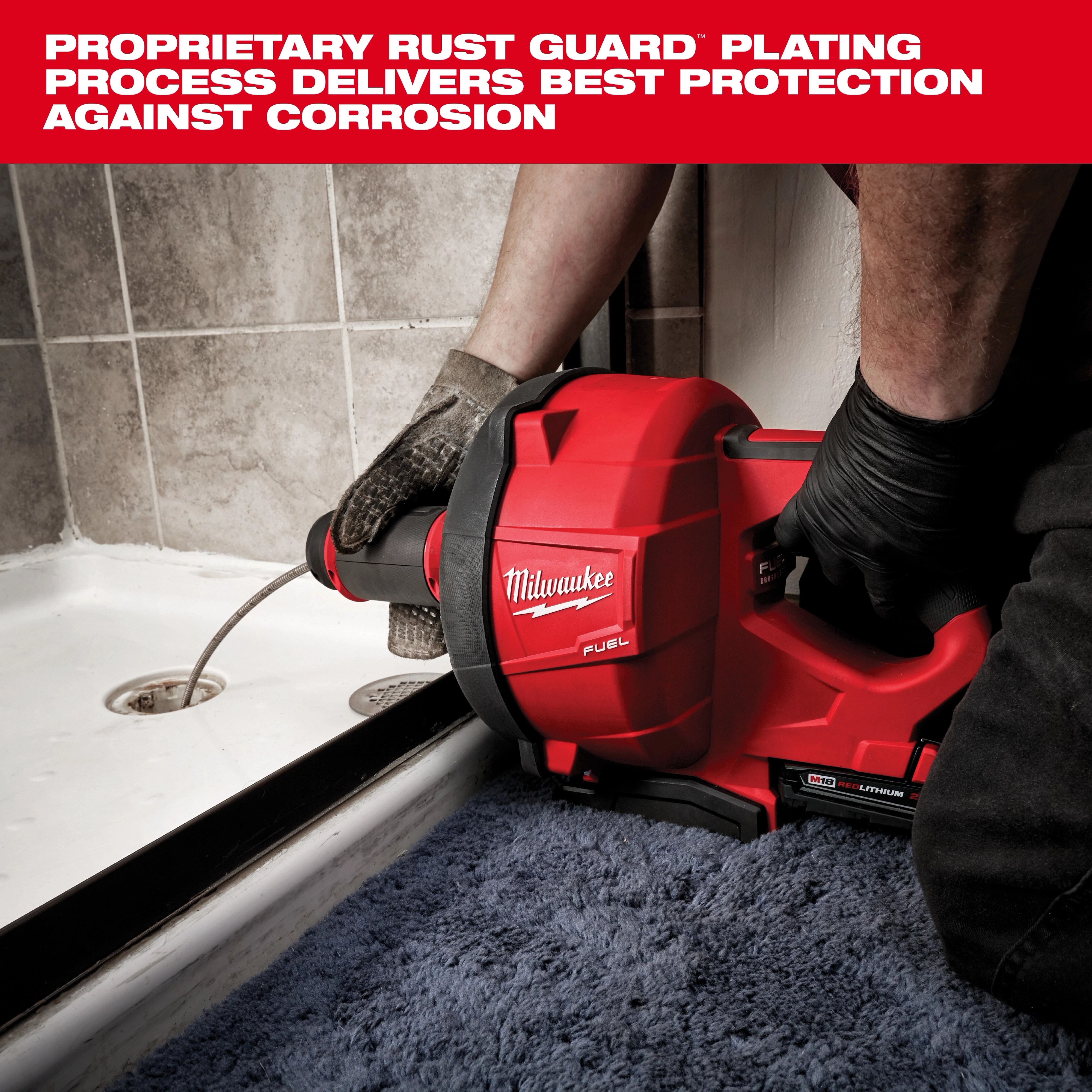 A Milwaukee Fuel power tool is being used to clear a clogged shower drain. The red device is held by a person wearing black gloves and operates on lithium-ion battery power. The image includes a text overlay promoting the tool's rust guard plating for corrosion protection.
