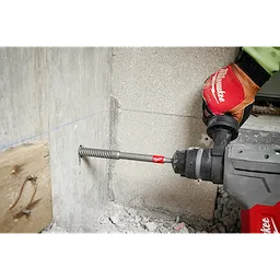 Worker using the SDS Plus 3/4" by 12" Rebar Cutter to drill through rebar