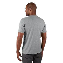 A man models the back view of the FREEFLEX Hybrid Work Tee - Short Sleeve in light gray, paired with dark gray pants.